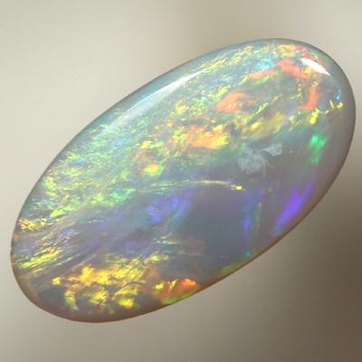 SOLID SEMI BLACK OPAL Orange and greens over ocean blue